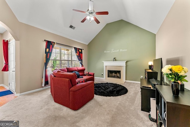 79 Tiffany Trce, Palmetto, GA 30268 - carpeted living area featuring visible vents, baseboards, ceiling fan, a fireplace, and arched walkways