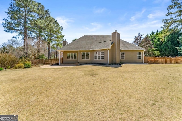 79 Tiffany Trce, Palmetto, GA 30268 - rear view of property featuring a patio, fence, a yard, and a chimney