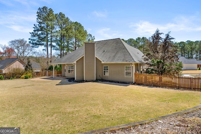 79 Tiffany Trce, Palmetto, GA 30268 - back of property with a lawn, a chimney, and fence private yard