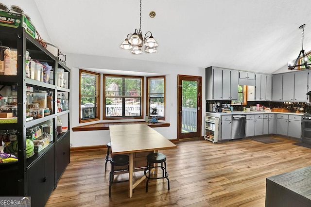 kitchen featuring light wood-type flooring, vaulted ceiling, an inviting chandelier, gray cabinets, and dishwasher