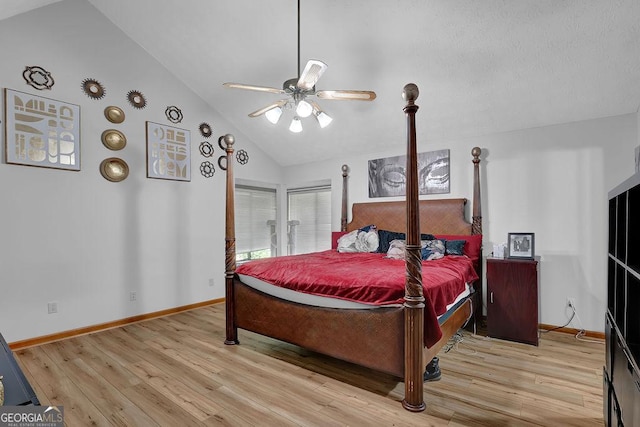 bedroom with lofted ceiling, wood finished floors, and baseboards