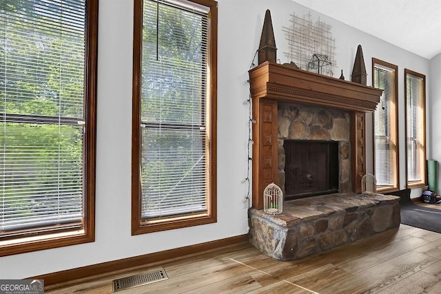 interior details with baseboards, wood finished floors, and visible vents