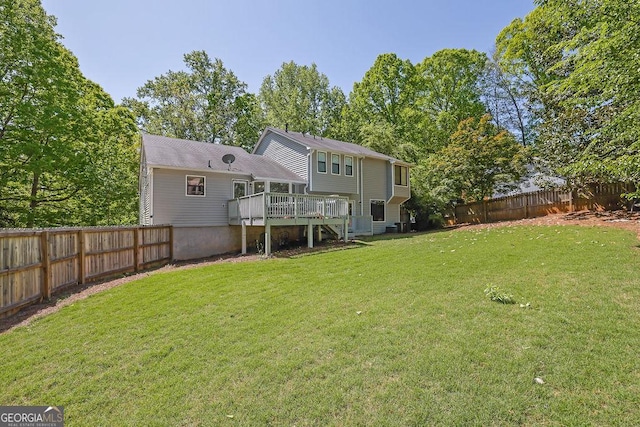 rear view of property with a wooden deck, a lawn, a fenced backyard, and stairs