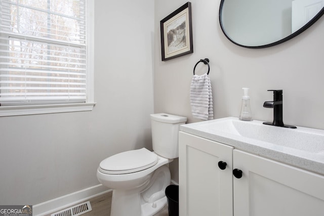 4215 Steeplehill Dr NW, Kennesaw, GA 30144 - half bath featuring healthy amount of natural light, vanity, and wood finished floors