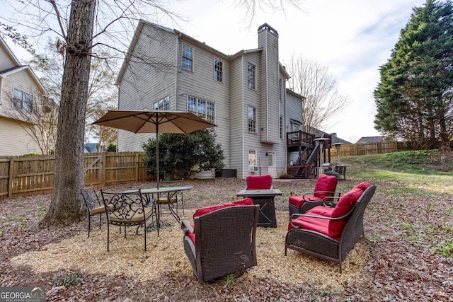 4215 Steeplehill Dr NW, Kennesaw, GA 30144 - rear view of house with a chimney, a fenced backyard, stairs, and a deck