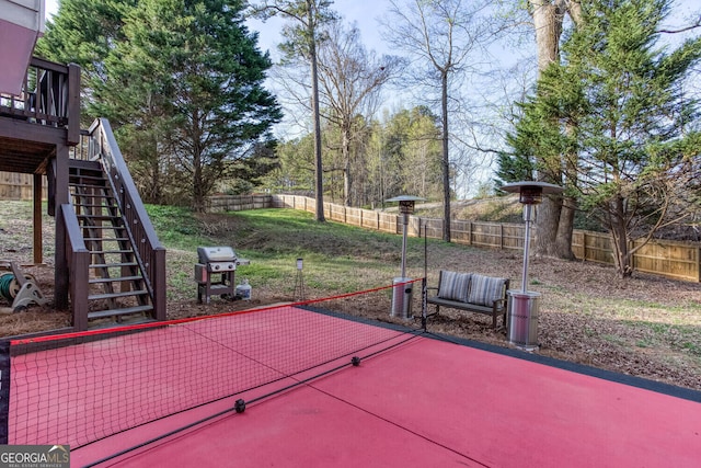 4215 Steeplehill Dr NW, Kennesaw, GA 30144 - fenced backyard featuring stairway, grilling area, a wooden deck, and a patio