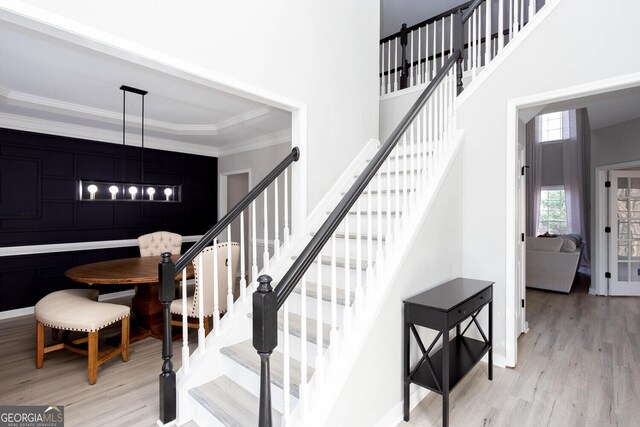 4215 Steeplehill Dr NW, Kennesaw, GA 30144 - stairs featuring a towering ceiling, wood finished floors, crown molding, and a chandelier