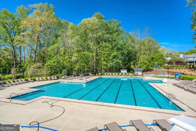 4215 Steeplehill Dr NW, Kennesaw, GA 30144 - community pool with a patio and view of scattered trees