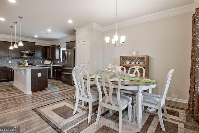 32 October Ave, Newnan, GA 30265 - dining area with crown molding, wood finished floors, recessed lighting, and a chandelier