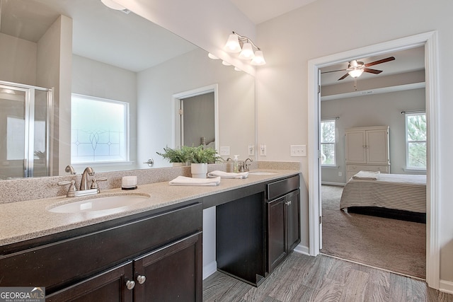32 October Ave, Newnan, GA 30265 - ensuite bathroom featuring double vanity, a stall shower, ceiling fan, wood finished floors, and baseboards