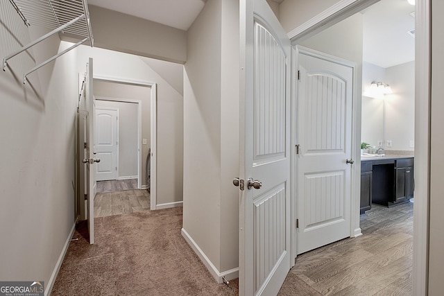 32 October Ave, Newnan, GA 30265 - hallway with baseboards, a sink, and light colored carpet