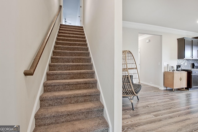 32 October Ave, Newnan, GA 30265 - staircase with wood finished floors, ornamental molding, and baseboards