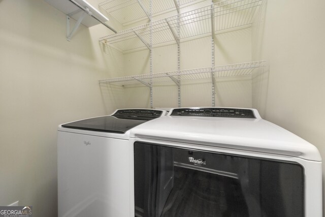 clothes washing area featuring washing machine and clothes dryer and laundry area