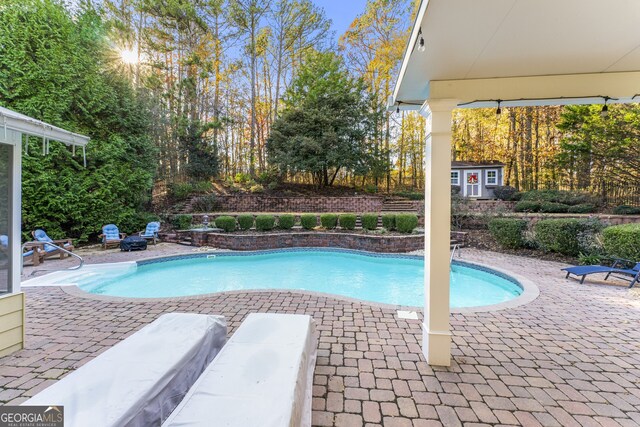 view of swimming pool with a fenced in pool and a patio area
