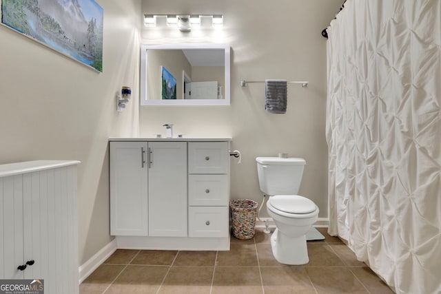full bath with radiator heating unit, vanity, tile patterned flooring, toilet, and baseboards