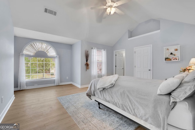 bedroom featuring light wood-type flooring, baseboards, multiple windows, and visible vents