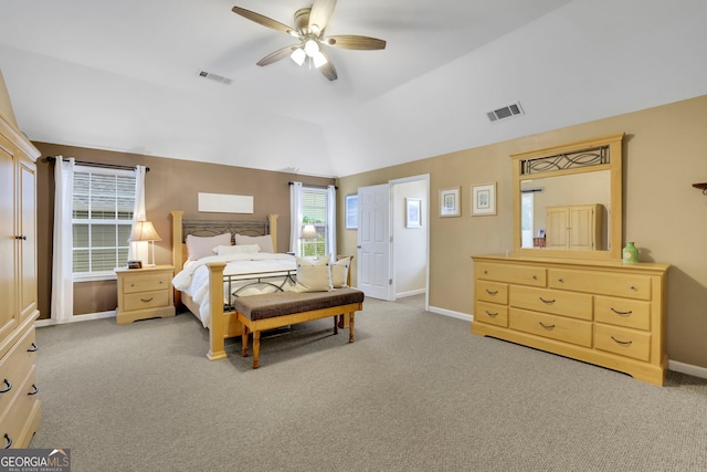 carpeted bedroom featuring a ceiling fan, baseboards, vaulted ceiling, and visible vents
