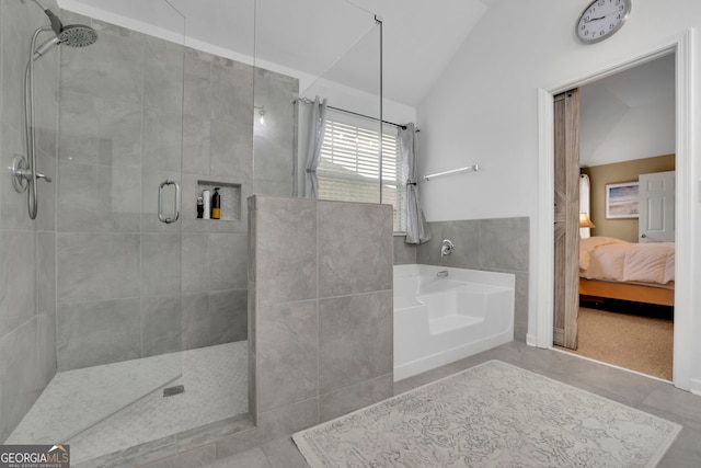 ensuite bathroom with ensuite bathroom, a bath, tile patterned floors, tiled shower, and lofted ceiling