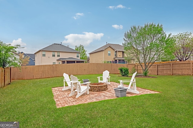 view of yard featuring a patio area, a fenced backyard, and a fire pit