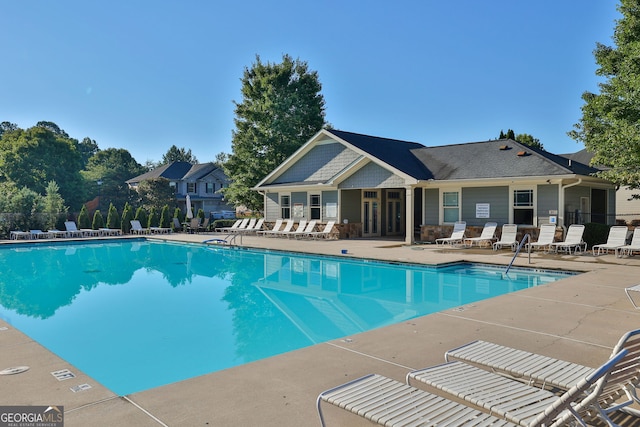 community pool featuring a patio area and fence