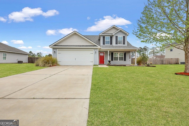 traditional-style home featuring driveway, a front yard, fence, and a garage
