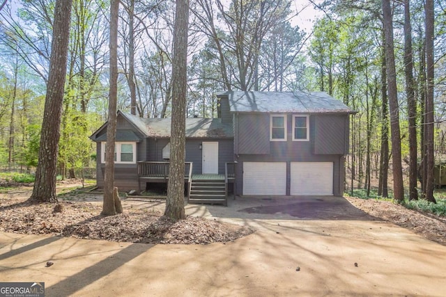 477 Victoria Rd, Woodstock, GA 30189 - view of front of home featuring asphalt driveway, a garage, and a wooden deck