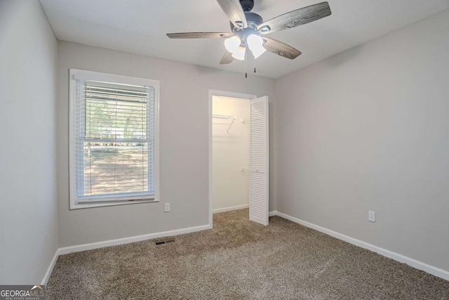 477 Victoria Rd, Woodstock, GA 30189 - unfurnished bedroom featuring carpet flooring, a closet, and a ceiling fan