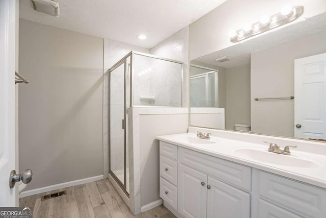 477 Victoria Rd, Woodstock, GA 30189 - full bath featuring a shower stall, wood finished floors, and double vanity