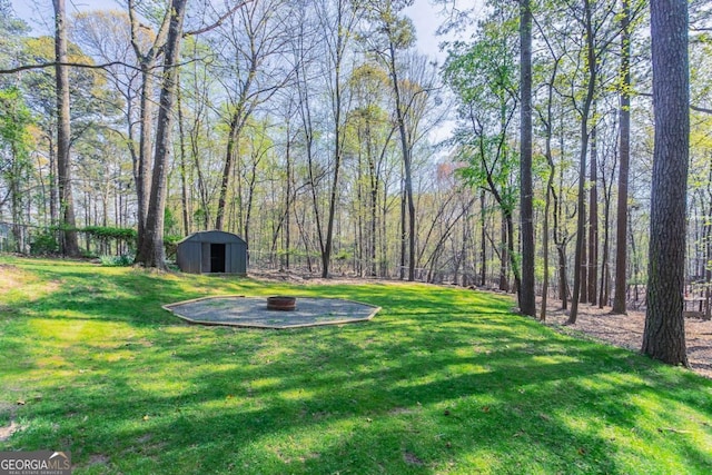 477 Victoria Rd, Woodstock, GA 30189 - view of yard with a shed and an outdoor fire pit