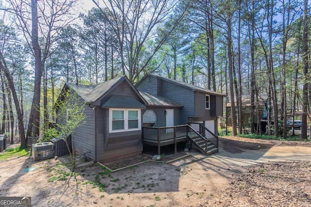 477 Victoria Rd, Woodstock, GA 30189 - view of front of home with a garage, concrete driveway, and a wooden deck