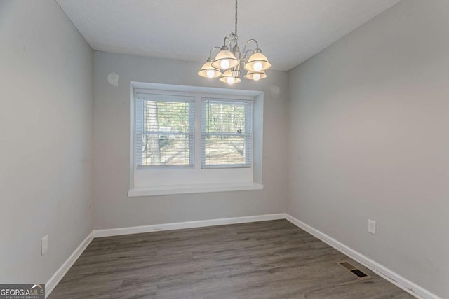 477 Victoria Rd, Woodstock, GA 30189 - unfurnished room with a chandelier and wood finished floors