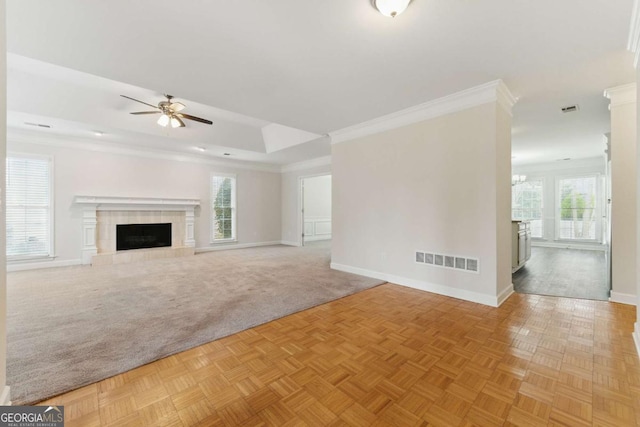 11925 N Hickory Trce, Alpharetta, GA 30004 - unfurnished living room featuring a tray ceiling, ornamental molding, baseboards, visible vents, and a ceiling fan