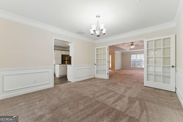 11925 N Hickory Trce, Alpharetta, GA 30004 - spare room with crown molding, french doors, carpet flooring, ceiling fan with notable chandelier, and wainscoting