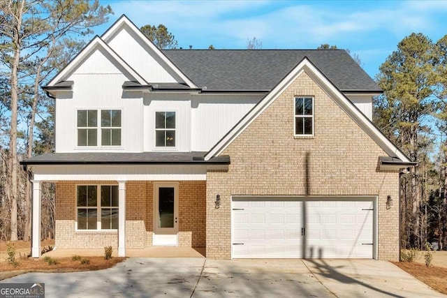 4444 Sullivan Rd, Powder Springs, GA 30127 - view of front facade with an attached garage, brick siding, concrete driveway, and a porch