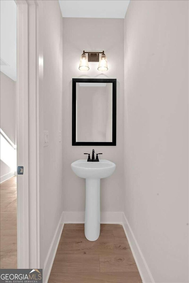 4444 Sullivan Rd, Powder Springs, GA 30127 - bathroom with baseboards and wood finished floors