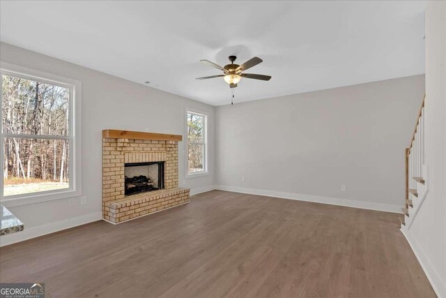 4444 Sullivan Rd, Powder Springs, GA 30127 - unfurnished living room featuring wood finished floors, baseboards, stairway, and ceiling fan