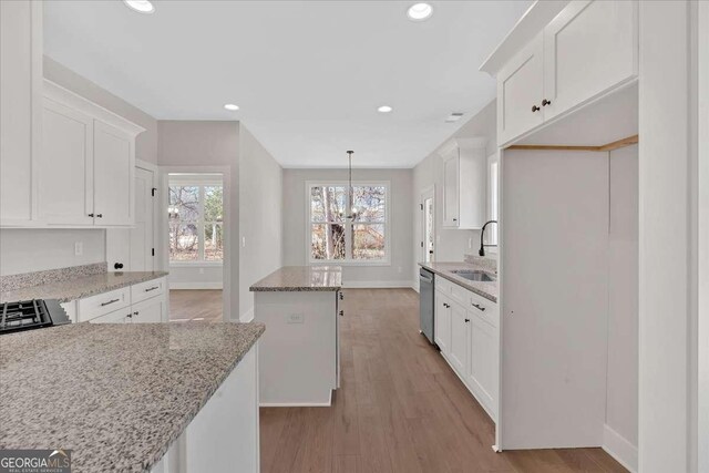 4444 Sullivan Rd, Powder Springs, GA 30127 - kitchen with light wood-style flooring, a sink, stainless steel dishwasher, and white cabinets