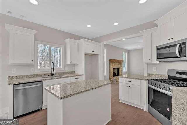 4444 Sullivan Rd, Powder Springs, GA 30127 - kitchen with white cabinetry, recessed lighting, a sink, and stainless steel appliances