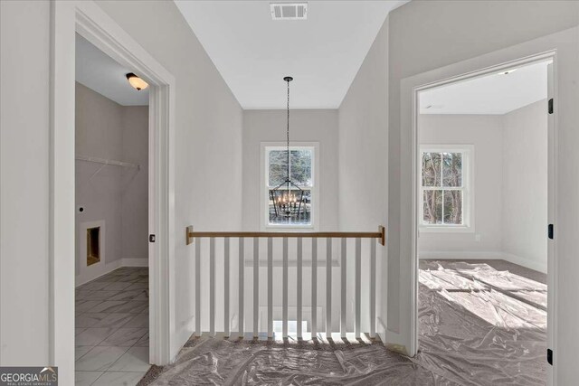4444 Sullivan Rd, Powder Springs, GA 30127 - hallway featuring baseboards, visible vents, and a chandelier