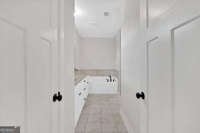 4444 Sullivan Rd, Powder Springs, GA 30127 - bathroom with vanity, baseboards, marble finish floor, a garden tub, and visible vents