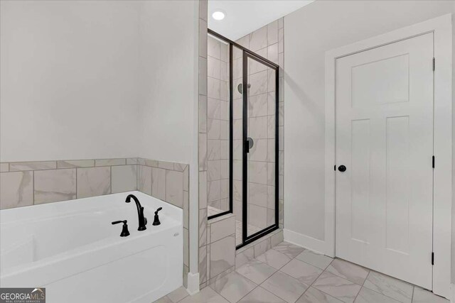4444 Sullivan Rd, Powder Springs, GA 30127 - bathroom with marble finish floor, a bath, and a shower stall