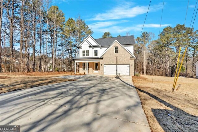 4444 Sullivan Rd, Powder Springs, GA 30127 - view of front of house featuring driveway, an attached garage, a porch, and brick siding