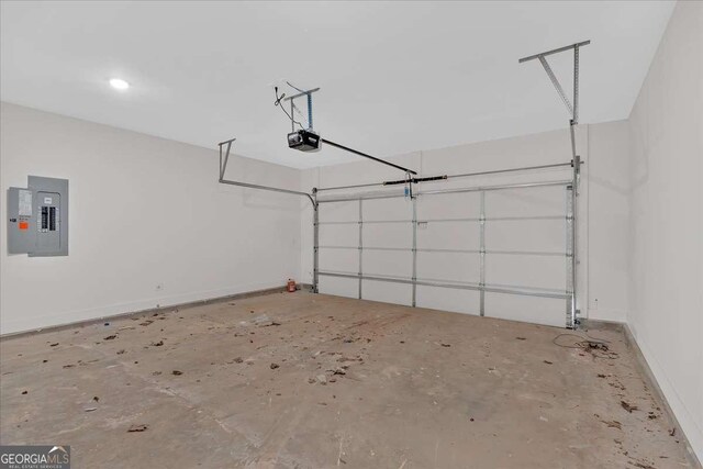 4444 Sullivan Rd, Powder Springs, GA 30127 - garage featuring baseboards, a garage door opener, and electric panel