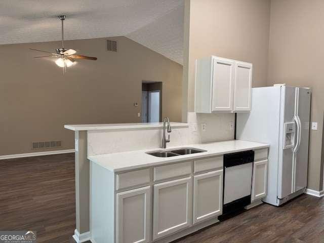 kitchen with visible vents, ceiling fan, white fridge with ice dispenser, a sink, and dishwashing machine