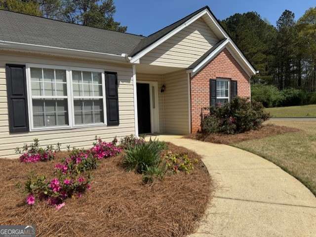 single story home with brick siding