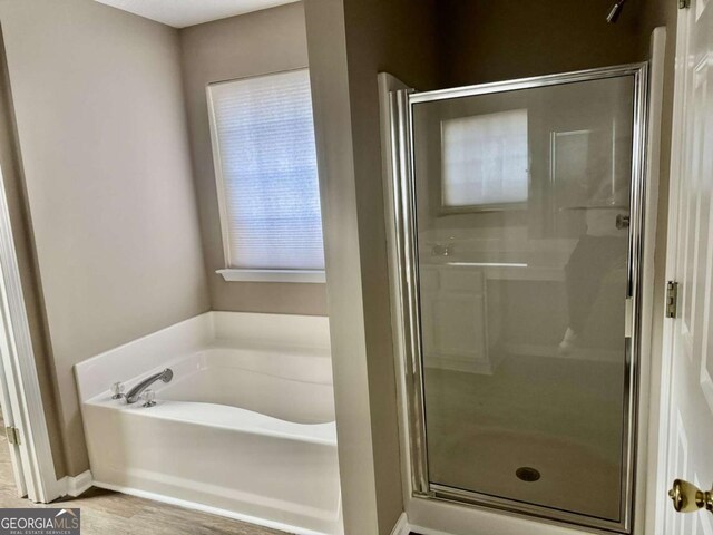 full bath featuring a shower stall and a bath
