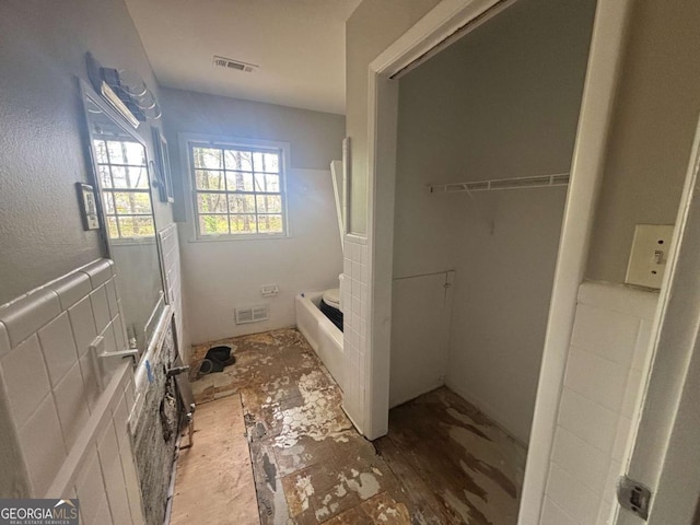 3488 Richmond Dr SE, Conyers, GA 30094 - bathroom featuring a garden tub and a closet