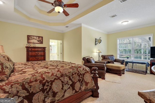 bedroom featuring visible vents, carpet, ornamental molding, ceiling fan, and a tray ceiling