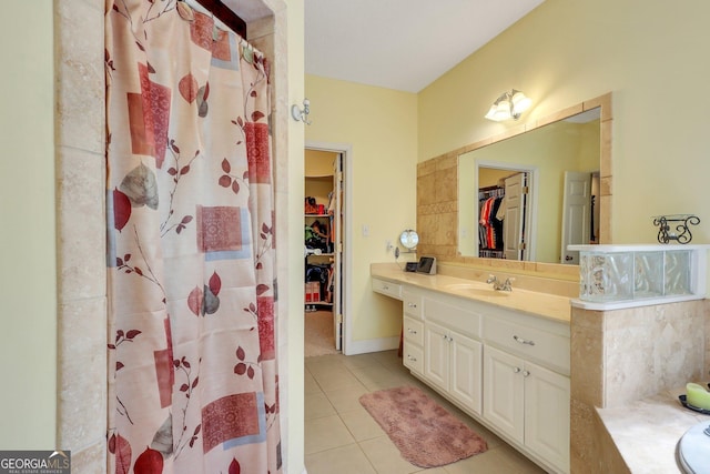 full bathroom featuring tile patterned floors, a spacious closet, vanity, and a shower with shower curtain