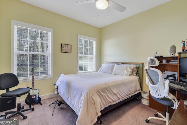 carpeted bedroom with baseboards and ceiling fan
